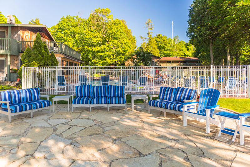 Blue striped deck chairs on stone patio
