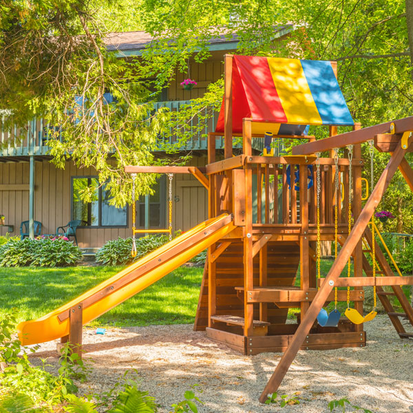 Playground surrounded by trees at the Shallows Resort