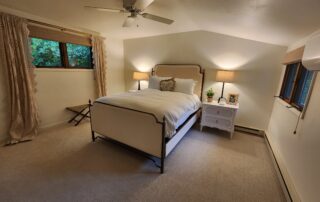 Interior of Shallows Cottage including couch, chairs, fireplace and large screen TV