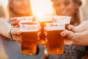 Group of people bringing their beer glasses together