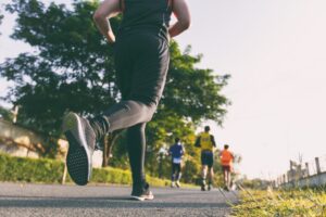 Group of people running on a paved trail