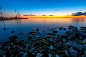 Rocky shorline of a bay next to a harbor