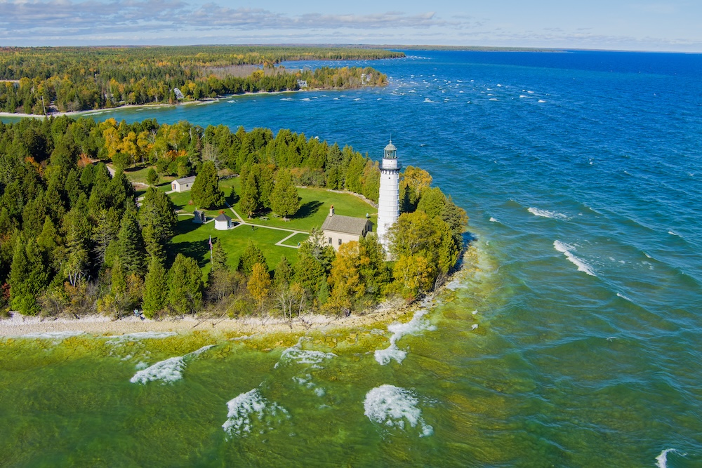 Aerial view of the Cana Island Lighthouse and its surrounding lake coastline