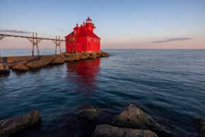 A red lighthouse at Sturgeon Bay at dusk